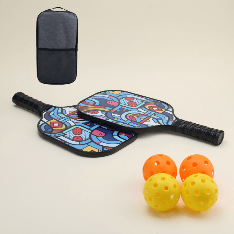 A beginner-friendly pickleball set featuring two paddles with modern, artistic patterns in bold, vibrant colors, two yellow hybrid pickleballs, two orange hybrid pickleballs, and a black carry bag, all arranged to showcase the unique and stylish design.