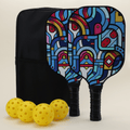 A pickleball set featuring two paddles with modern, artistic patterns in bold, vibrant colors, each with a black paddle cover, four yellow pickleballs, and a black pickleball carry bag, all neatly arranged to highlight the unique and stylish design.