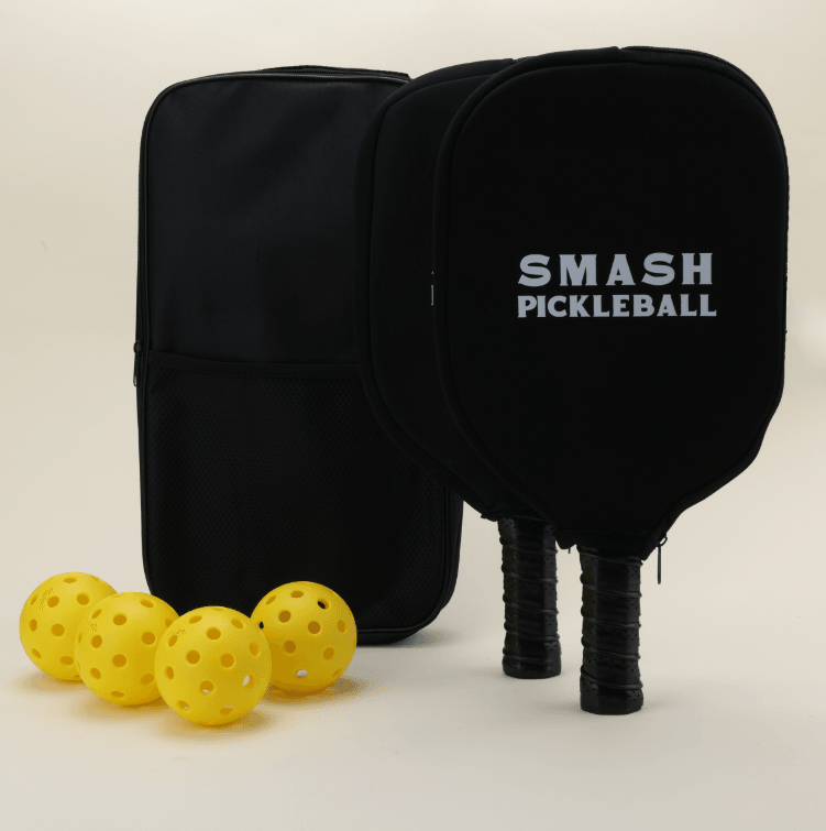 A pickleball set featuring two paddles with modern, artistic patterns in bold, vibrant colors, each with a branded black paddle cover, four yellow pickleballs, and a black pickleball carry bag, all neatly arranged to highlight the unique and stylish design.