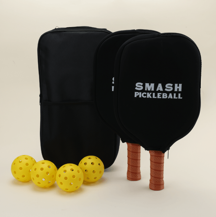 A pickleball set featuring two paddles with vibrant, sports-themed patterns in bold colors, two paddle covers, four yellow pickleballs, and a black pickleball carry bag, all neatly arranged to highlight the energetic design.