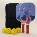 A pickleball set including two paddles with vibrant, sports-themed patterns in bold colors, four yellow pickleballs, and a black pickleball carry bag, arranged neatly to showcase the energetic design.