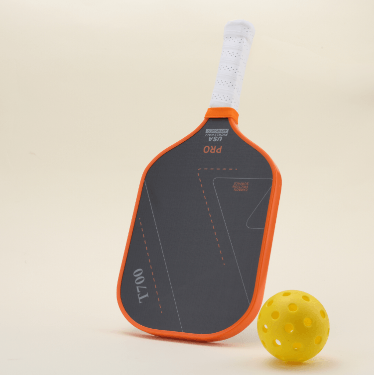 A yellow hybrid pickleball and a performance pickleball paddle with a modern orange-and-black design, placed side by side, showcasing both style and functionality.