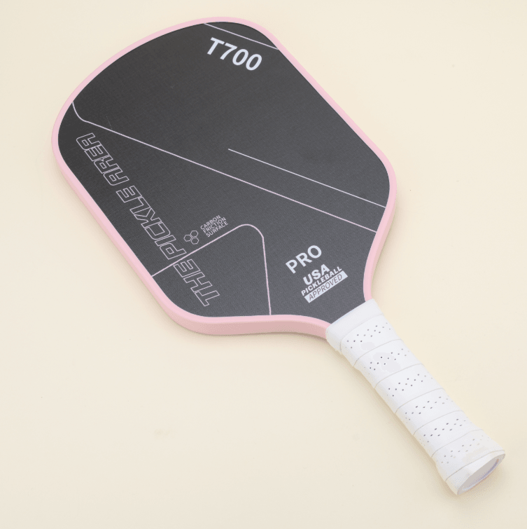 Affordable T700 pickleball paddle in a sleek black and pink color combination, featuring a white grip, resting on a flat surface.