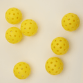 Arranged in 2 sets of three, three, 7 yellow hybrid pickleball.