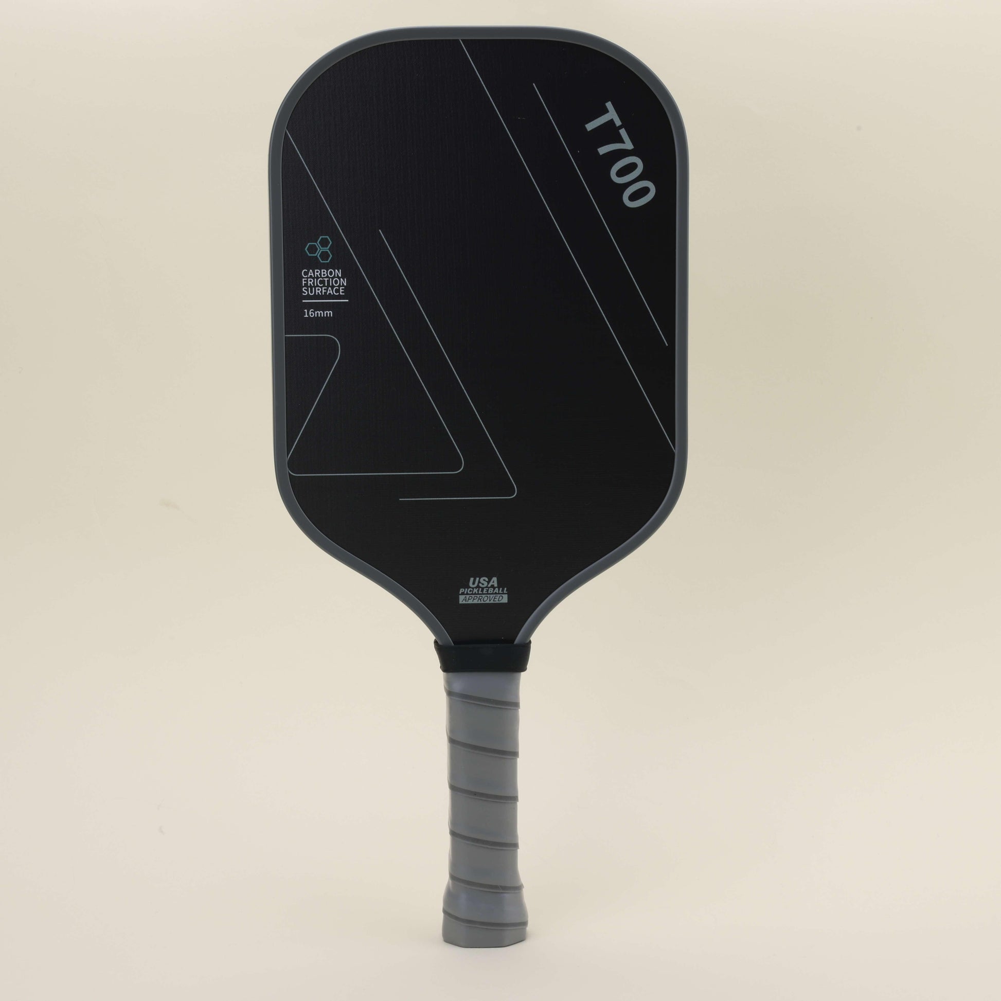 Front view of a pickleball paddle with a sleek black-gray color scheme and geometric patterns, paired with a yellow hybrid pickleball resting on the surface, showcasing a blend of modern style, power, and control.