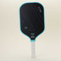 Front view of a pickleball paddle with vibrant blue representing passion and bold black conveying strength, paired with a yellow hybrid pickleball, showcasing a striking color combination that blends style with functionality.
