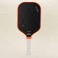 Performance pickleball paddle featuring a modern orange-and-black design, representing contemporary trends and making the paddle stand out on the court with both style and functionality.