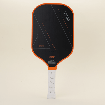 Performance pickleball paddle featuring a modern orange-and-black design, representing contemporary trends and making the paddle stand out on the court with both style and functionality.