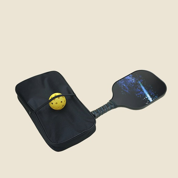 A pickleball set featuring a black paddle with a galaxy design, a yellow ball, and a protective carrying case for easy storage and transport. The paddle handle is made with durable grip material, perfect for outdoor sports and convenient carrying.