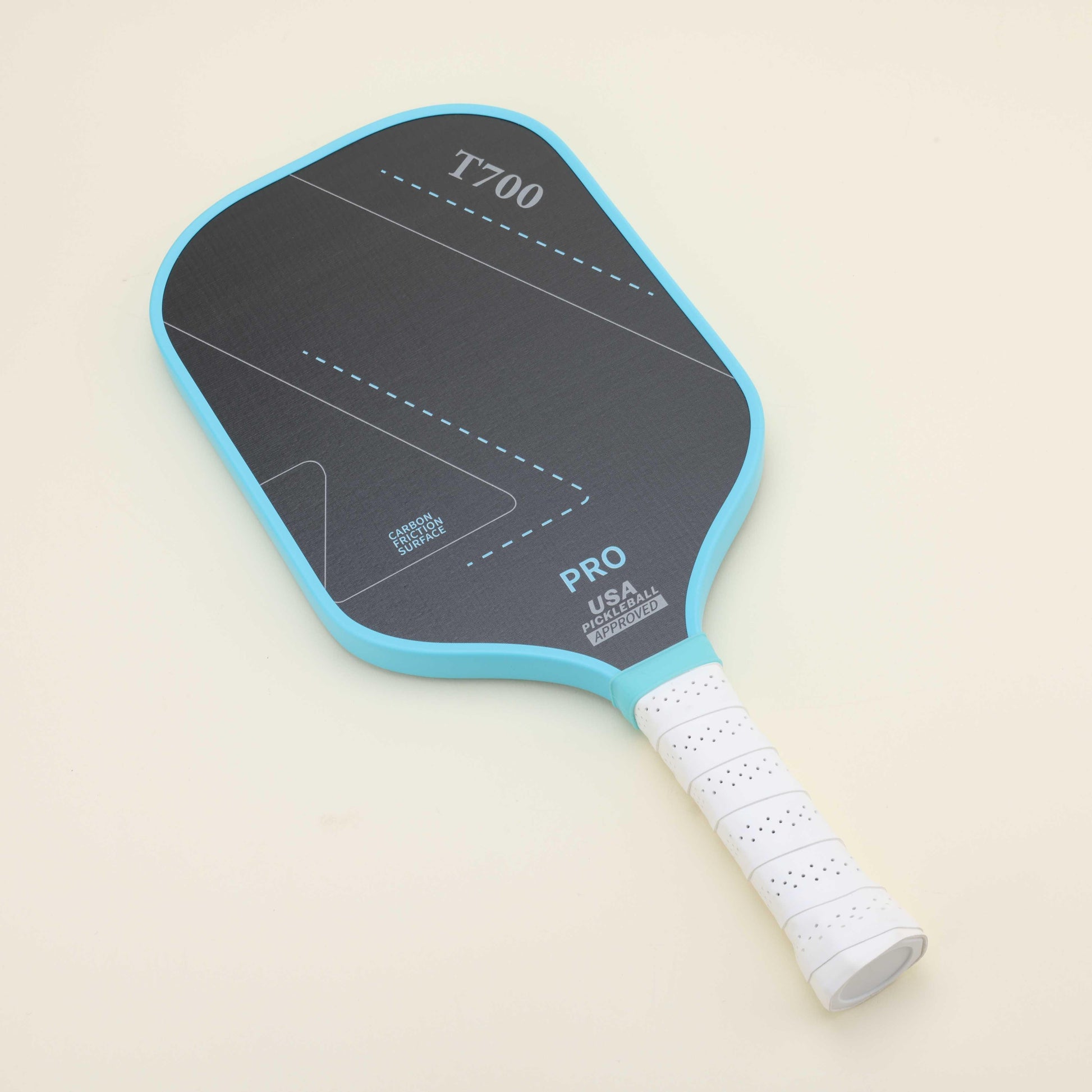 Pickleball paddle with vibrant blue representing passion and bold black conveying strength, laying on the floor next to a yellow hybrid pickleball, showcasing a striking color combination that blends style with functionality.
