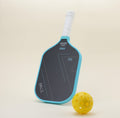 Pickleball paddle with vibrant blue representing passion and bold black conveying strength, paired with a yellow hybrid pickleball, creating a striking color combination that blends style with functionality.