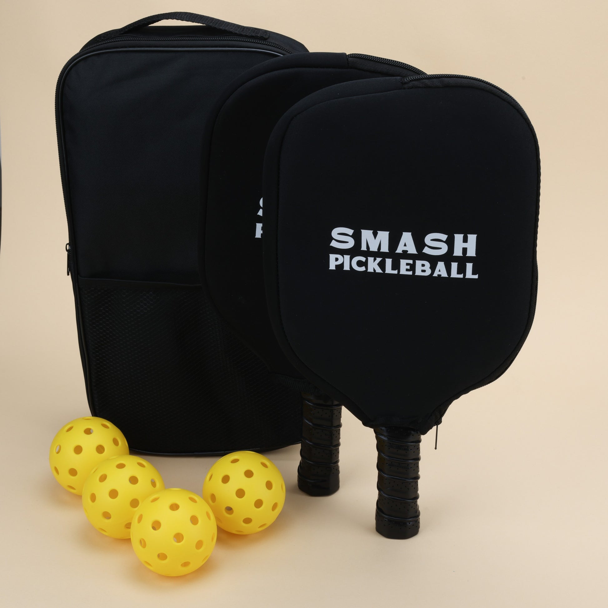 "Smash Pickleball set with black paddles featuring the logo, a black backpack, and yellow pickleballs."

