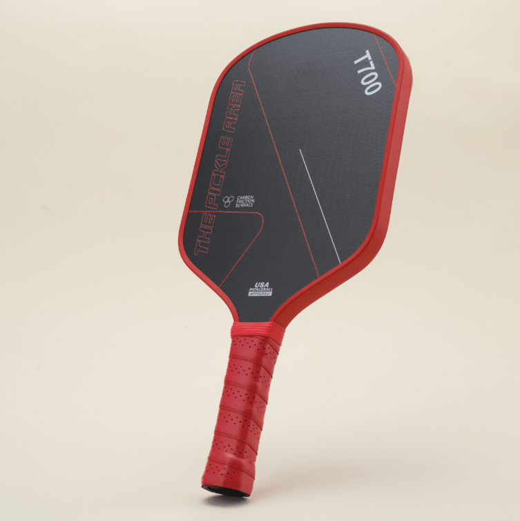 T700 Carbon Fiber pickleball paddle viewed from the left angle, featuring a striking red-and-black color combination that showcases passion and power. The modern design with geometric line patterns offers visual impact.