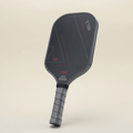 T700 Carbon Fiber pickleball paddle viewed from the left angle, showcasing its sleek black-and-gray color scheme with geometric line patterns.