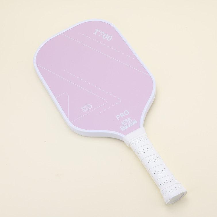 T700 pickleball paddle with an elegant and modern pink design, laying on the floor, adding a trendy touch to your game, ideal for younger players and families.