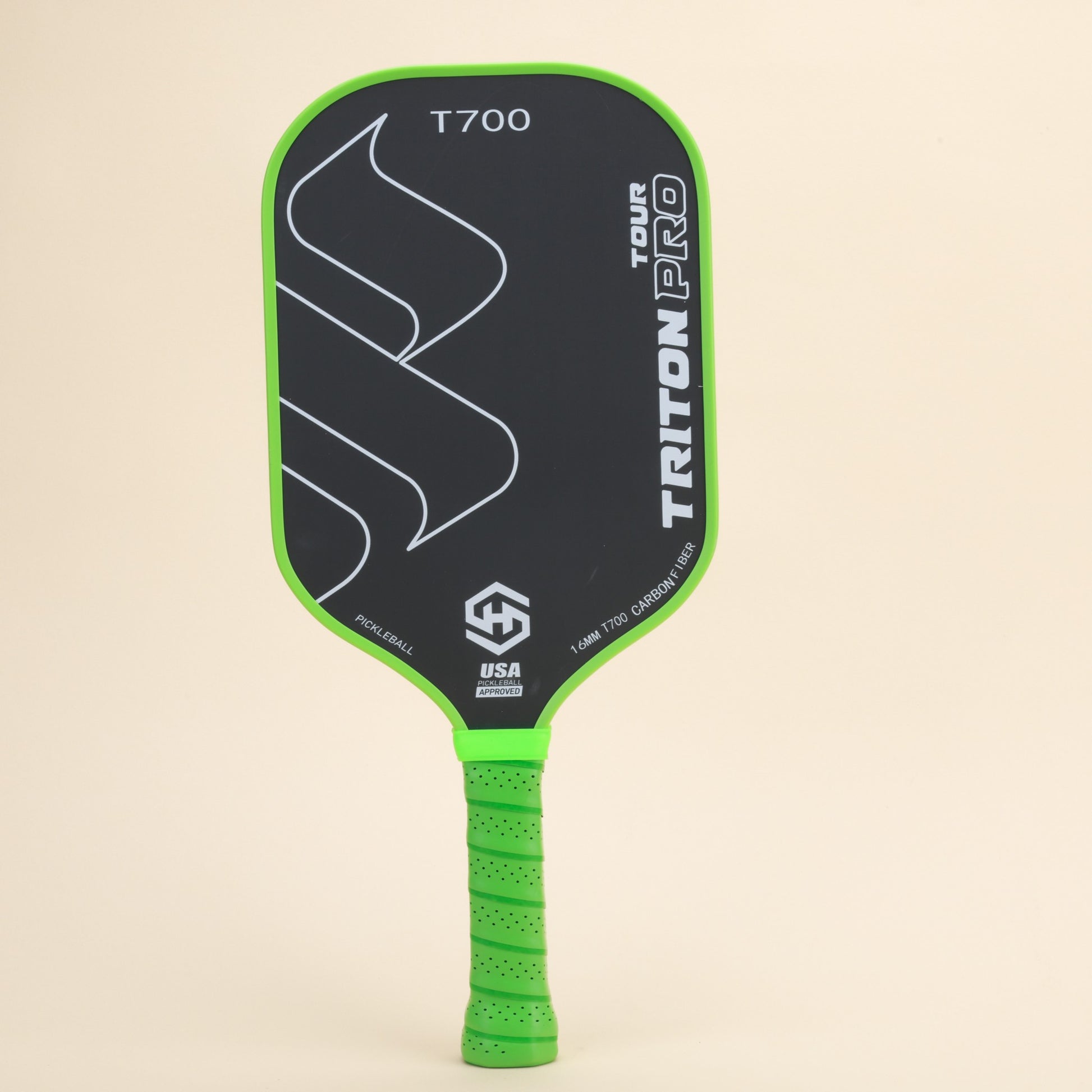 "Close-up of Triton Pro T700 pickleball paddle, featuring a green ergonomic grip and carbon fiber construction, designed for high-performance gameplay and precision control."