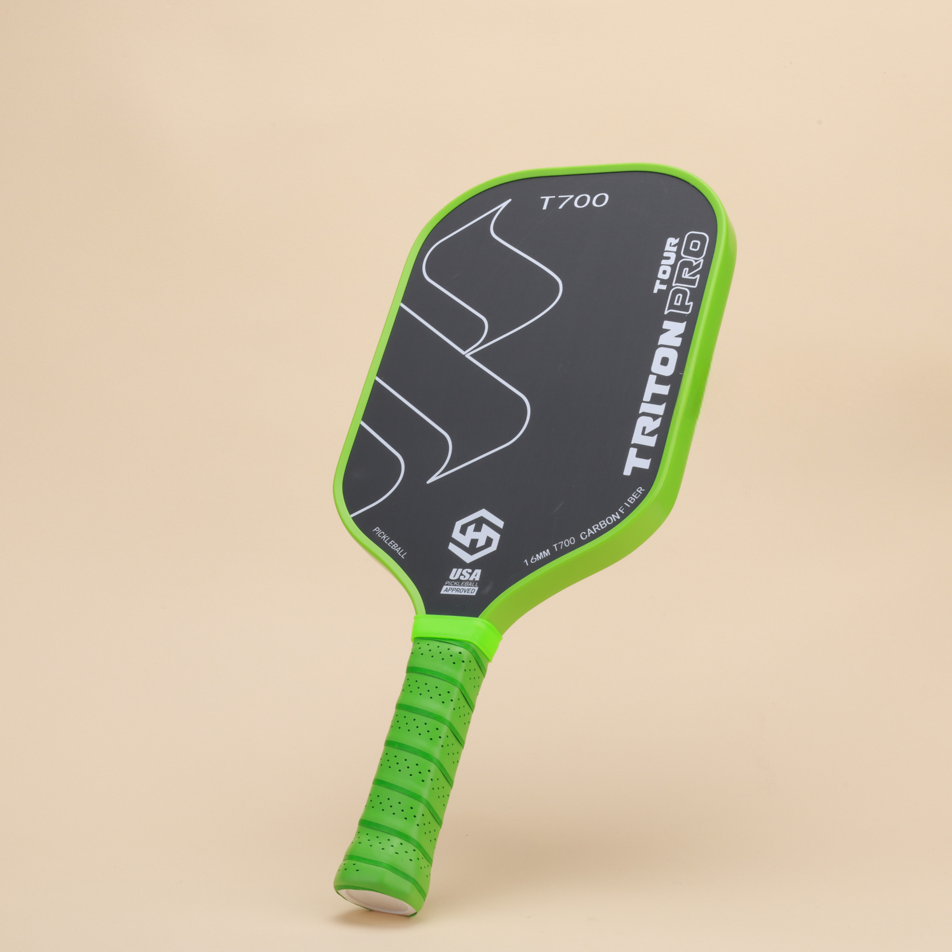 "Close-up of Triton Pro T700 pickleball paddle showcasing its ergonomic green grip and carbon fiber construction, designed for high-performance and precision in pickleball games."
