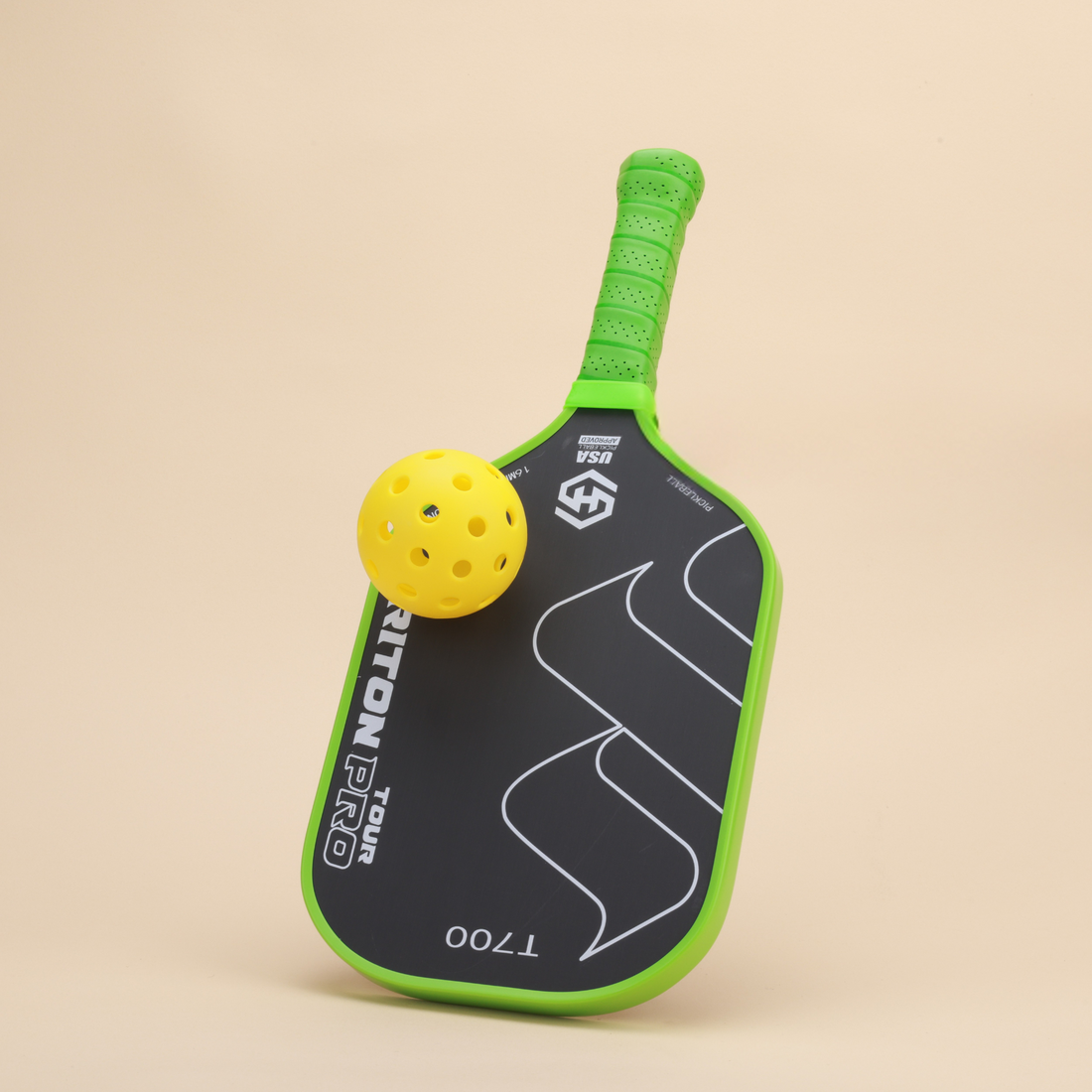 "High-performance Triton Pro T700 pickleball paddle with a yellow ball, featuring a green ergonomic grip and sleek design. Perfect for players seeking control and precision."