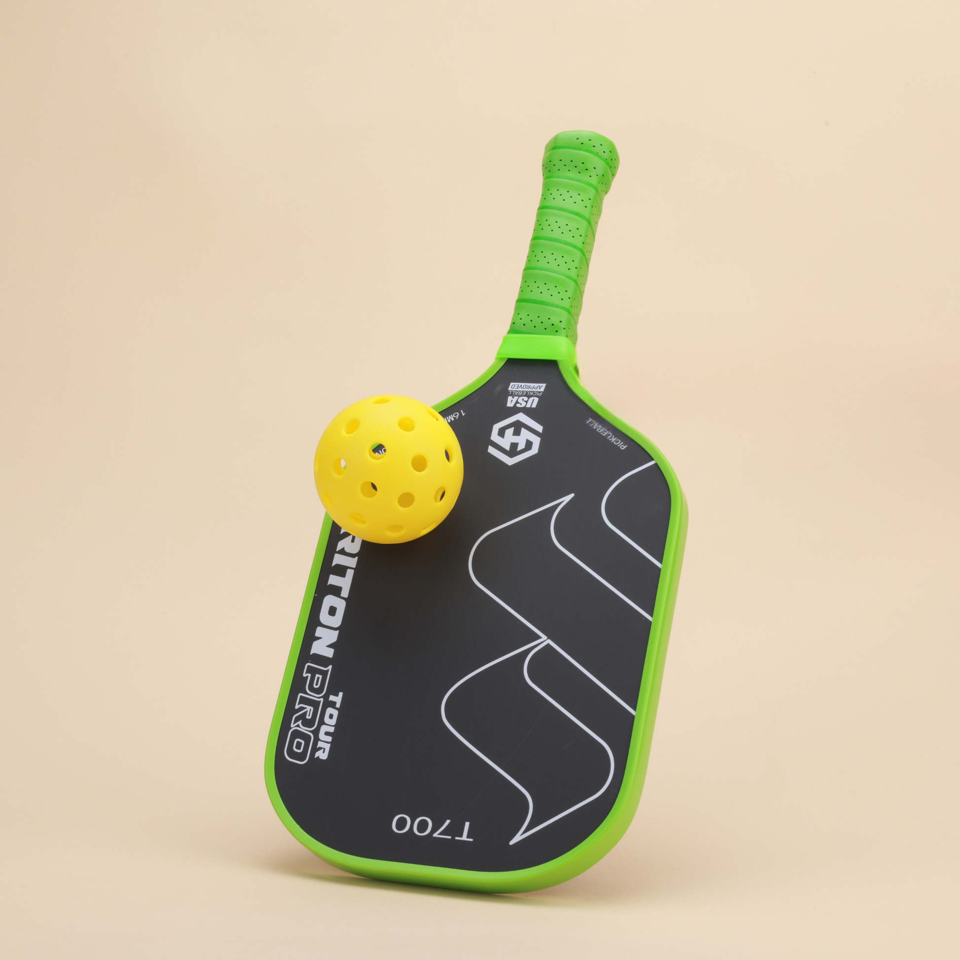 "High-performance Triton Pro T700 pickleball paddle with a yellow ball, featuring a green ergonomic grip and sleek design. Perfect for players seeking control and precision."