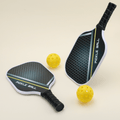 Two All Season 2 pickleball paddles, featuring a stylish design, paired with two yellow hybrid pickleballs, arranged neatly on a surface.