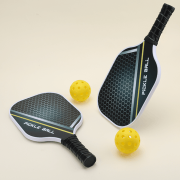 Two All Season 2 pickleball paddles, featuring a stylish design, paired with two yellow hybrid pickleballs, arranged neatly on a surface.