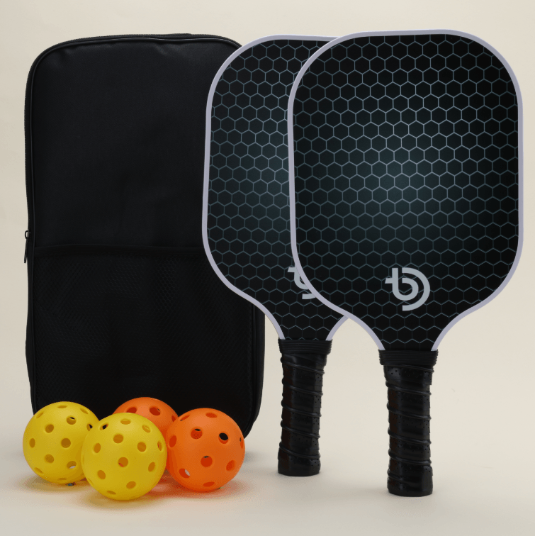 USA-approved pickleball set featuring 2 paddles in front view with a minimalistic design, 4 pickleballs (2 yellow and 2 orange), and 1 black Smash Pickleball branded carry bag, perfect for both recreational and competitive play.