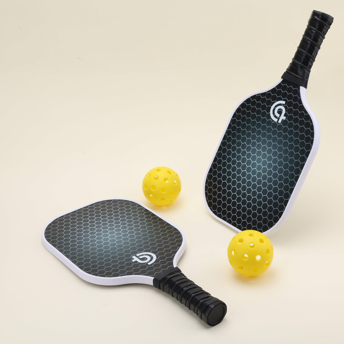 USA-approved pickleball set with 2 minimalistic, stylish paddles featuring a classic mesh pattern and black finish, 4 yellow pickleballs, 2 black Smash Pickleball branded paddle covers, and 1 black carry bag, ideal for both recreational and competitive play.